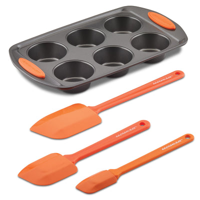 Muffin tray with three orange silicone spatulas.