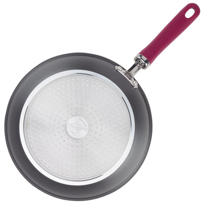 Nonstick frying pan with a red handle, viewed from above.