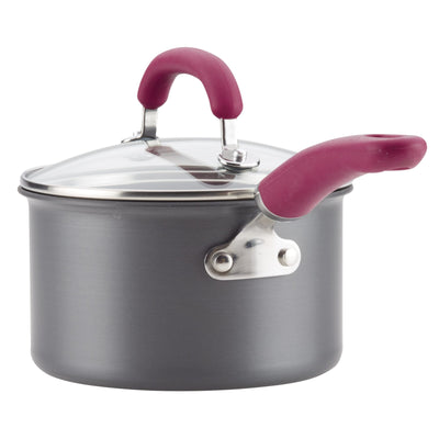 Gray cooking pot with a glass lid and red handles.