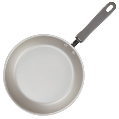 A nonstick frying pan with a grey handle on a white background.