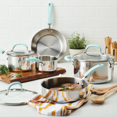 A cookware set with pots, pans, and utensils on a kitchen counter.