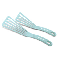Two light blue slotted spatulas with text on the handles.