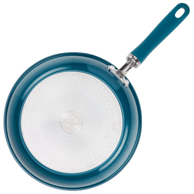 Blue frying pan with a white, textured bottom and a blue handle.