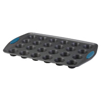 The 24-Cup Nonstick Mini Muffin Pan features blue silicone grips and is ideal for baking delicious mini muffins. It's oven safe, making baking convenient every time.
