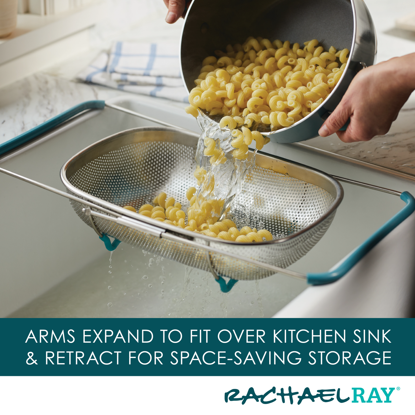 Hands pouring cooked pasta into the 4.5 Quart Over-the-Sink Colander, its expandable arms perfectly bridging the kitchen sink.