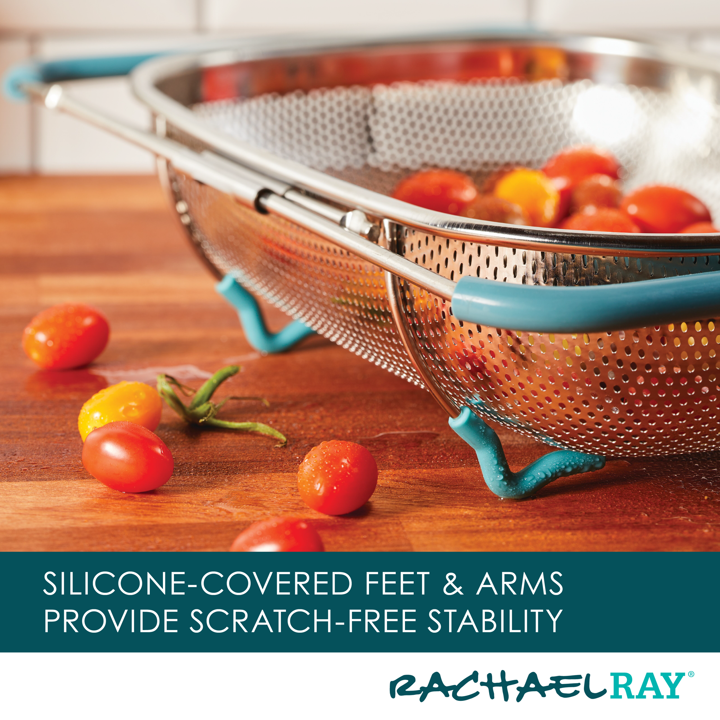 The 4.5 Quart Over-the-Sink Colander with silicone feet cradles cherry tomatoes on a wooden surface.