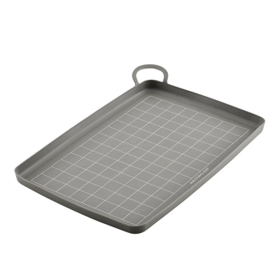 Nonstick Silicone Roasting and Baking Mat in grey features a rectangular shape with a grid pattern and comes with a convenient handle on one side for easy transfer from oven to counter; it's also dishwasher safe for hassle-free cleaning.