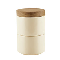 The Stacking Spice Box Set includes a beige, ceramic cylindrical container with a wooden lid, ideal for organizing and stacking your spices.