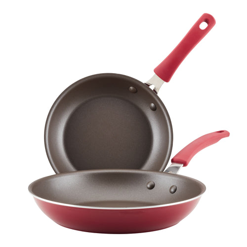 A set of two frying pans from the Cook + Create Nonstick Frying Pan Set, featuring nonstick interiors, durable aluminum construction, and matching red handles.