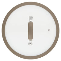 A glass lid, featuring a beige handle and rim, seen from above, is designed to complement the 3-Quart Cook + Create Nonstick Sauté Pan with Lid.