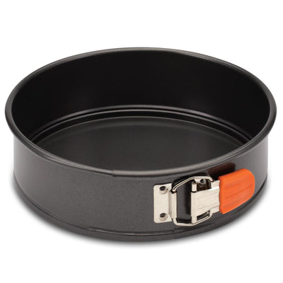 9-Inch Nonstick Springform Pan made from heavy gauge steel, equipped with a round design and an orange latch on the side for easy food release.