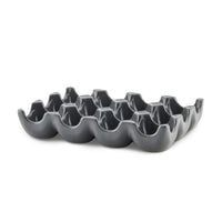 The 12-Cup Ceramic Egg Tray in modern gray is ideal for holding a dozen eggs or serving as a versatile hors d'oeuvres tray.