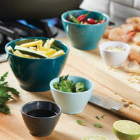 A vibrant display of the 10-Piece Mix, Measure, and Utensil Set brimming with ingredients graces the kitchen countertop, showcasing the true essence of kitchen essentials.