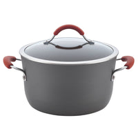 Part of the 12-Piece Cucina Hard Anodized Nonstick Cookware Set, this spacious black pot is constructed from sturdy aluminum, featuring a glass lid and vibrant red handles for easy food release.