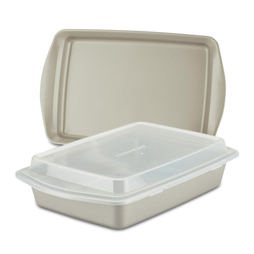 The 3-Piece Nonstick Covered Cake Pan & Baking Sheet Set, featuring a beige pan made from heavy gauge steel, includes a snug-fitting lid that nests inside a larger one, making it ideal for all your baking endeavors.