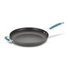 The 14-Inch Cucina Hard Anodized Nonstick Frying Pan with Helper Handle offers a nonstick surface, enhanced by a long handle and a comfortable blue grip, making it perfect for any culinary task.