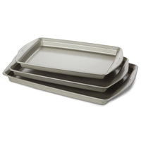 Introducing the "3-Piece Nonstick Jumbo Sheet Pan Set," a collection of three gray baking trays designed to nestle together perfectly. Crafted from heavy gauge steel, these nonstick cookie pans ensure durability and even heat distribution. They are oven safe, meeting all your baking needs with reliable performance every time.