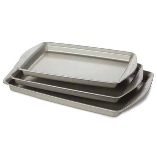 Introducing the "3-Piece Nonstick Jumbo Sheet Pan Set," a collection of three gray baking trays designed to nestle together perfectly. Crafted from heavy gauge steel, these nonstick cookie pans ensure durability and even heat distribution. They are oven safe, meeting all your baking needs with reliable performance every time.