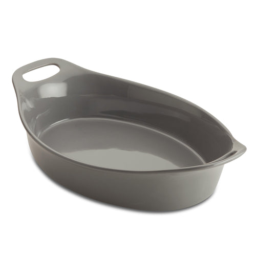 The Ceramic Oval Bakers, featuring a convenient handle, sits empty against a pristine white background. Designed for versatility, it transitions effortlessly from freezer to oven, making your culinary creations both stylish and effortless.
