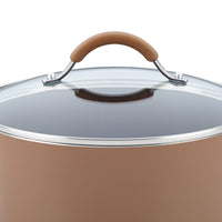 The 12-Piece Cucina Nonstick Cookware Set features a brown pot with a glass lid and brown handle, viewed from the side, highlighting the elegance of this durable aluminum cookware collection.