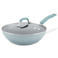 The 11-Inch Classic Brights Nonstick Covered Stir Fry pan in teal features a premium nonstick surface, a glass lid, and an ergonomic handle with an aluminum design, making it perfect for your culinary needs on a white background.